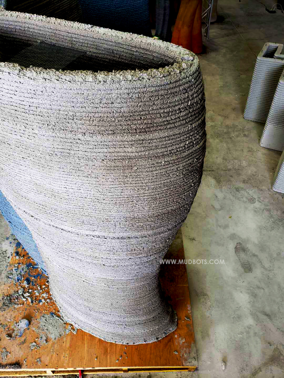 Print tall, cylindrical concrete structures with varying size and shapes.